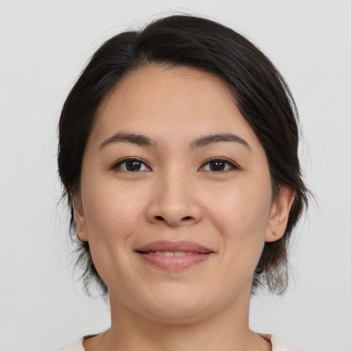Joyful asian young-adult female with medium  brown hair and brown eyes
