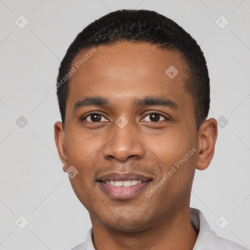 Joyful black young-adult male with short  black hair and brown eyes