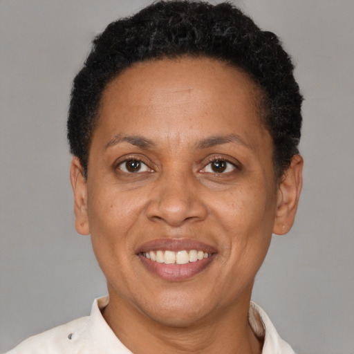 Joyful latino adult female with short  brown hair and brown eyes