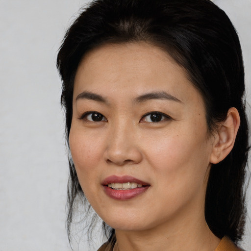 Joyful asian young-adult female with medium  black hair and brown eyes