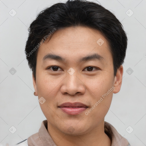 Joyful asian young-adult male with short  brown hair and brown eyes