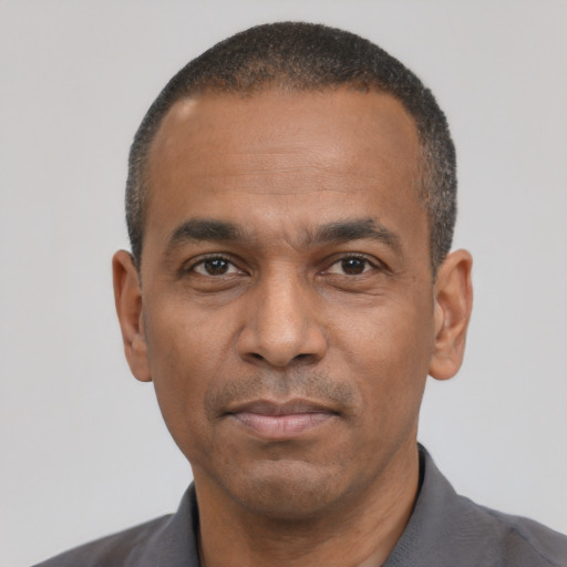 Neutral latino adult male with short  black hair and brown eyes
