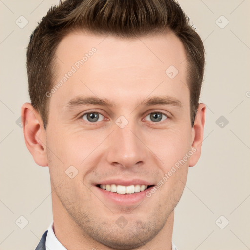 Joyful white young-adult male with short  brown hair and grey eyes