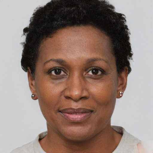 Joyful black adult female with short  black hair and brown eyes