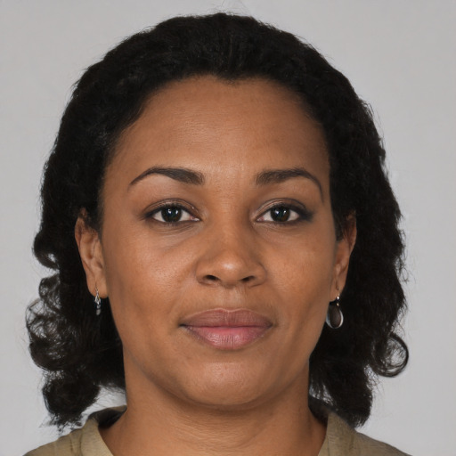 Joyful black adult female with medium  black hair and brown eyes
