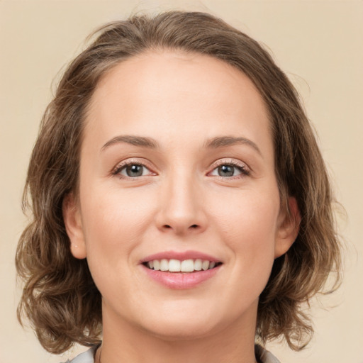 Joyful white young-adult female with medium  brown hair and green eyes