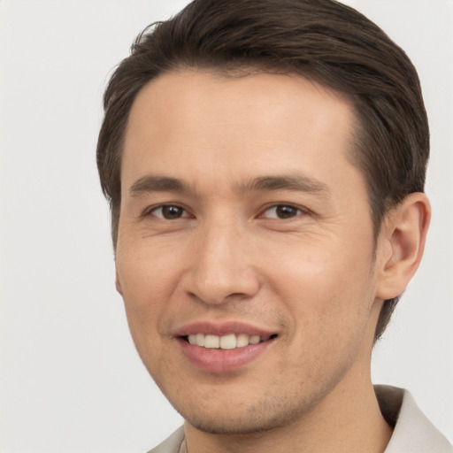 Joyful white young-adult male with short  brown hair and brown eyes