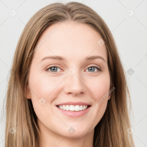 Joyful white young-adult female with long  brown hair and blue eyes