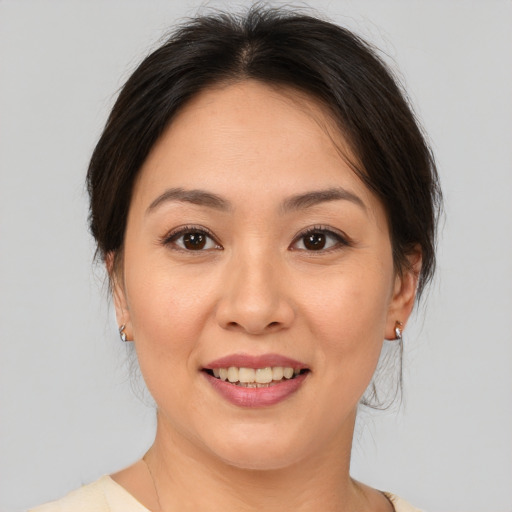 Joyful asian young-adult female with medium  brown hair and brown eyes