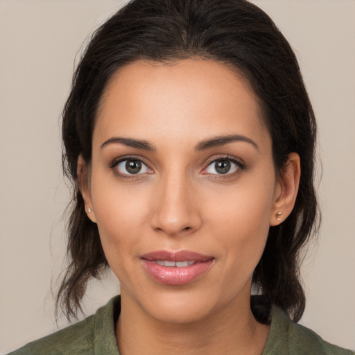 Joyful latino young-adult female with medium  brown hair and brown eyes