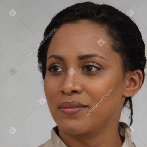 Joyful black young-adult female with medium  black hair and brown eyes