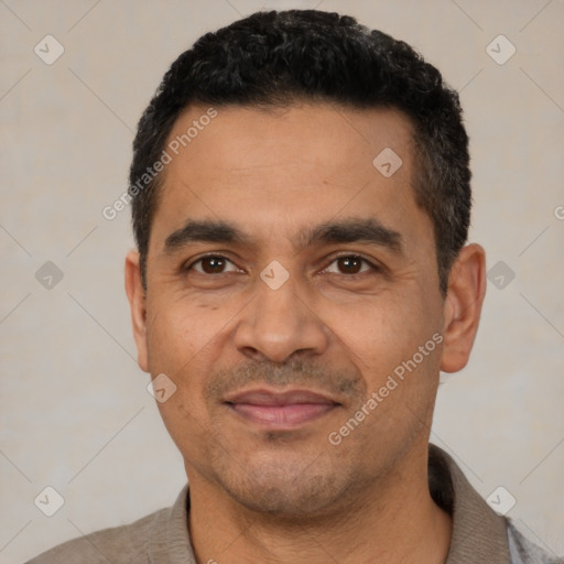 Joyful latino adult male with short  black hair and brown eyes