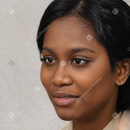 Joyful black young-adult female with short  black hair and brown eyes