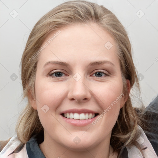 Joyful white young-adult female with medium  brown hair and blue eyes