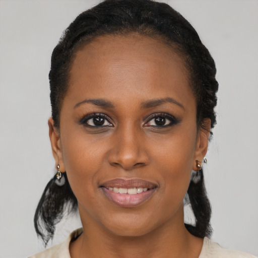 Joyful black young-adult female with short  brown hair and brown eyes