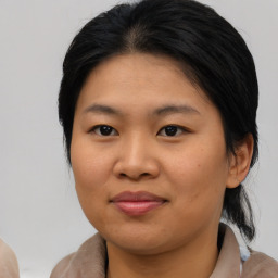 Joyful asian young-adult female with medium  brown hair and brown eyes