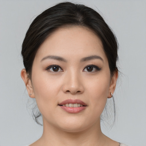 Joyful asian young-adult female with medium  black hair and brown eyes