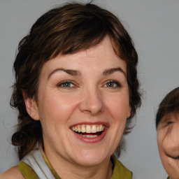 Joyful white adult female with medium  brown hair and brown eyes