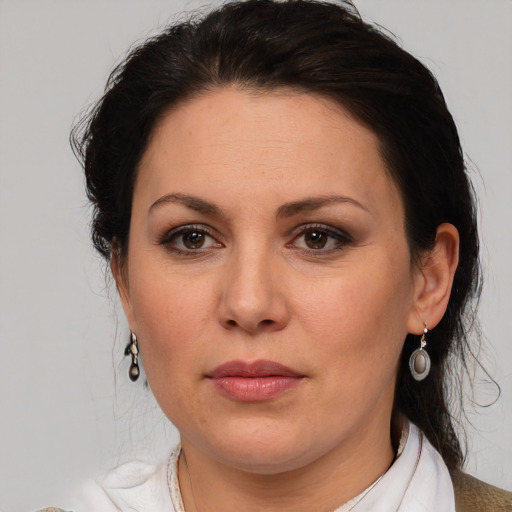 Joyful white adult female with medium  brown hair and brown eyes