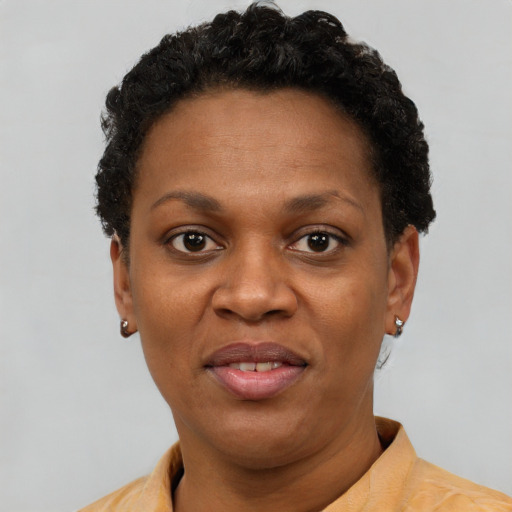 Joyful black adult female with short  brown hair and brown eyes