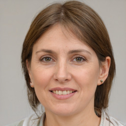 Joyful white adult female with medium  brown hair and grey eyes