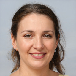 Joyful white adult female with medium  brown hair and brown eyes