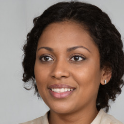 Joyful black young-adult female with medium  brown hair and brown eyes