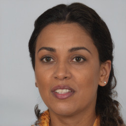 Joyful black adult female with medium  brown hair and brown eyes