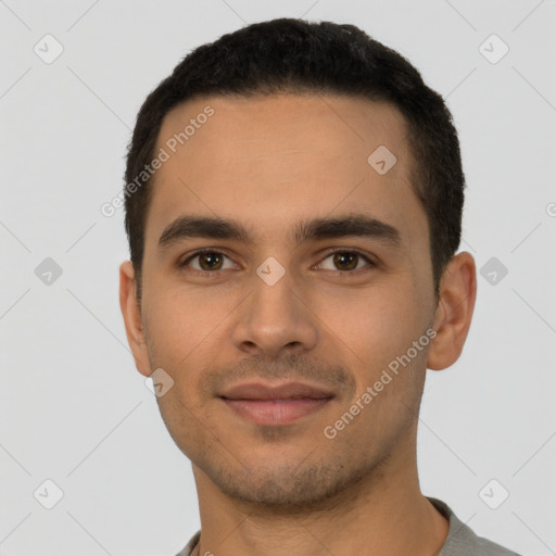 Joyful latino young-adult male with short  brown hair and brown eyes