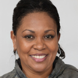 Joyful black adult female with short  brown hair and brown eyes