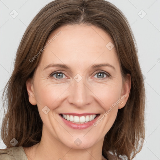 Joyful white adult female with medium  brown hair and grey eyes