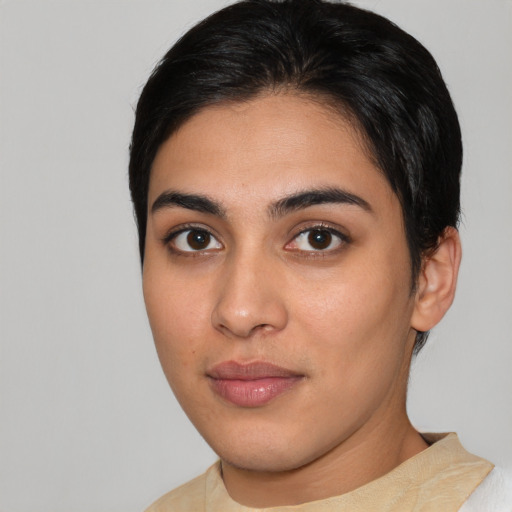 Joyful latino young-adult female with short  brown hair and brown eyes