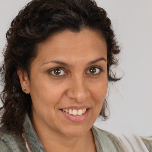 Joyful white adult female with long  brown hair and brown eyes