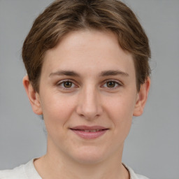 Joyful white young-adult female with short  brown hair and grey eyes