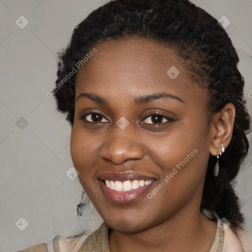 Joyful black young-adult female with medium  black hair and brown eyes