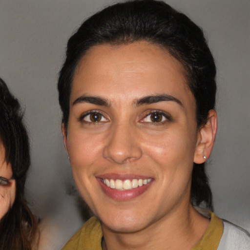 Joyful white young-adult female with medium  brown hair and brown eyes