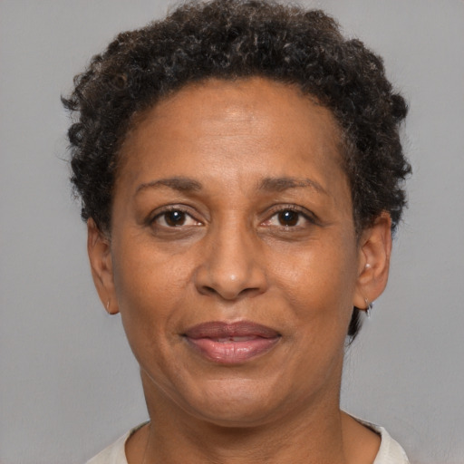 Joyful black adult female with short  brown hair and brown eyes