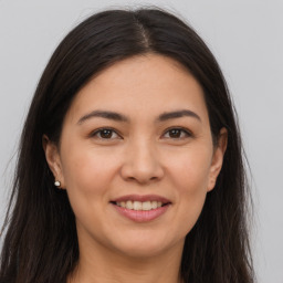 Joyful white young-adult female with long  brown hair and brown eyes