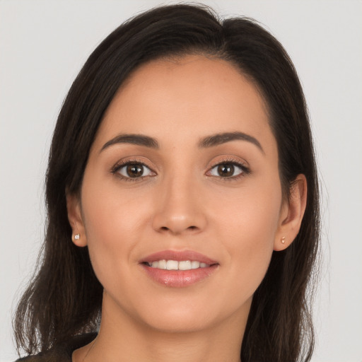 Joyful white young-adult female with long  brown hair and brown eyes