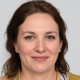 Joyful white adult female with medium  brown hair and grey eyes