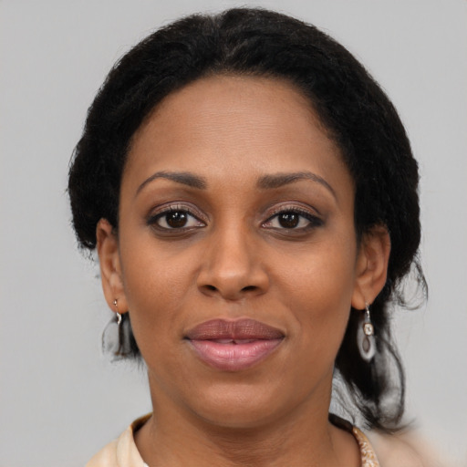Joyful latino adult female with medium  black hair and brown eyes