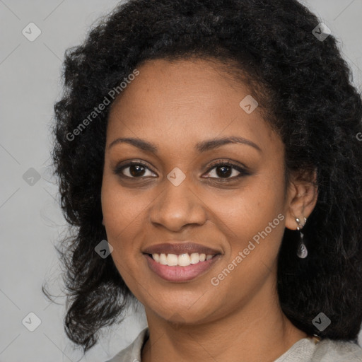 Joyful black young-adult female with long  black hair and brown eyes