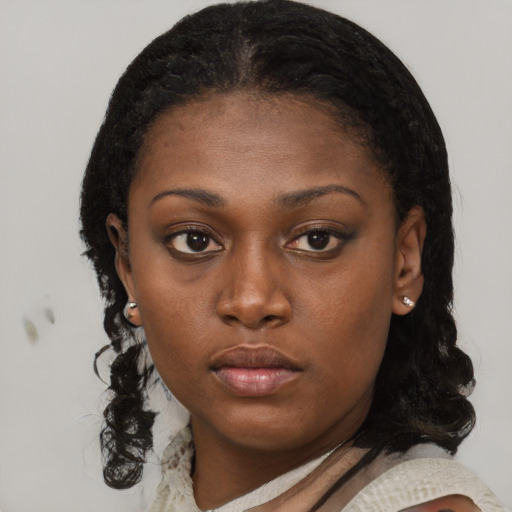 Neutral black young-adult female with medium  brown hair and brown eyes