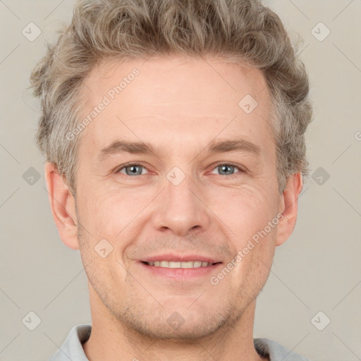 Joyful white adult male with short  brown hair and grey eyes