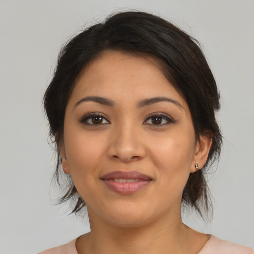 Joyful latino young-adult female with medium  brown hair and brown eyes