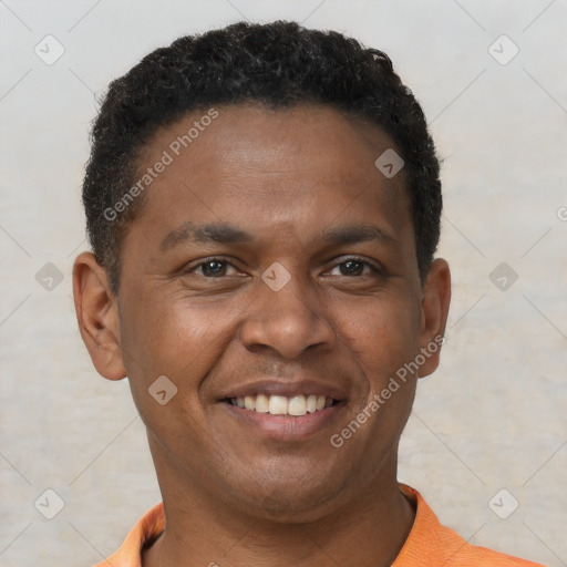 Joyful black young-adult male with short  brown hair and brown eyes