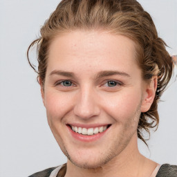 Joyful white young-adult female with medium  brown hair and blue eyes