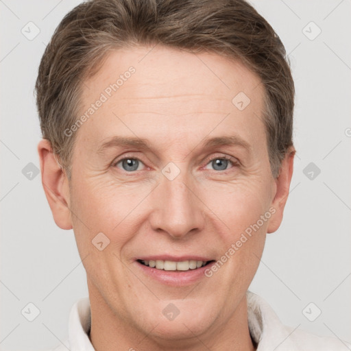 Joyful white adult male with short  brown hair and grey eyes