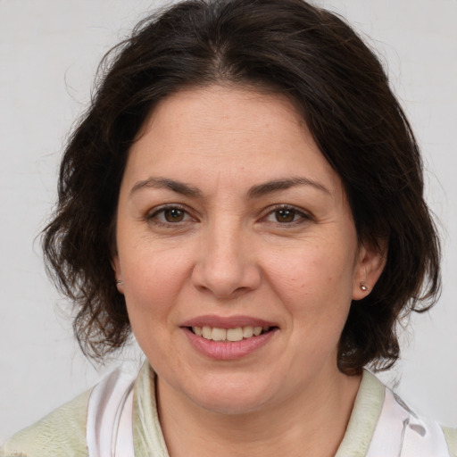 Joyful white adult female with medium  brown hair and brown eyes