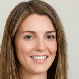 Joyful white young-adult female with long  brown hair and green eyes